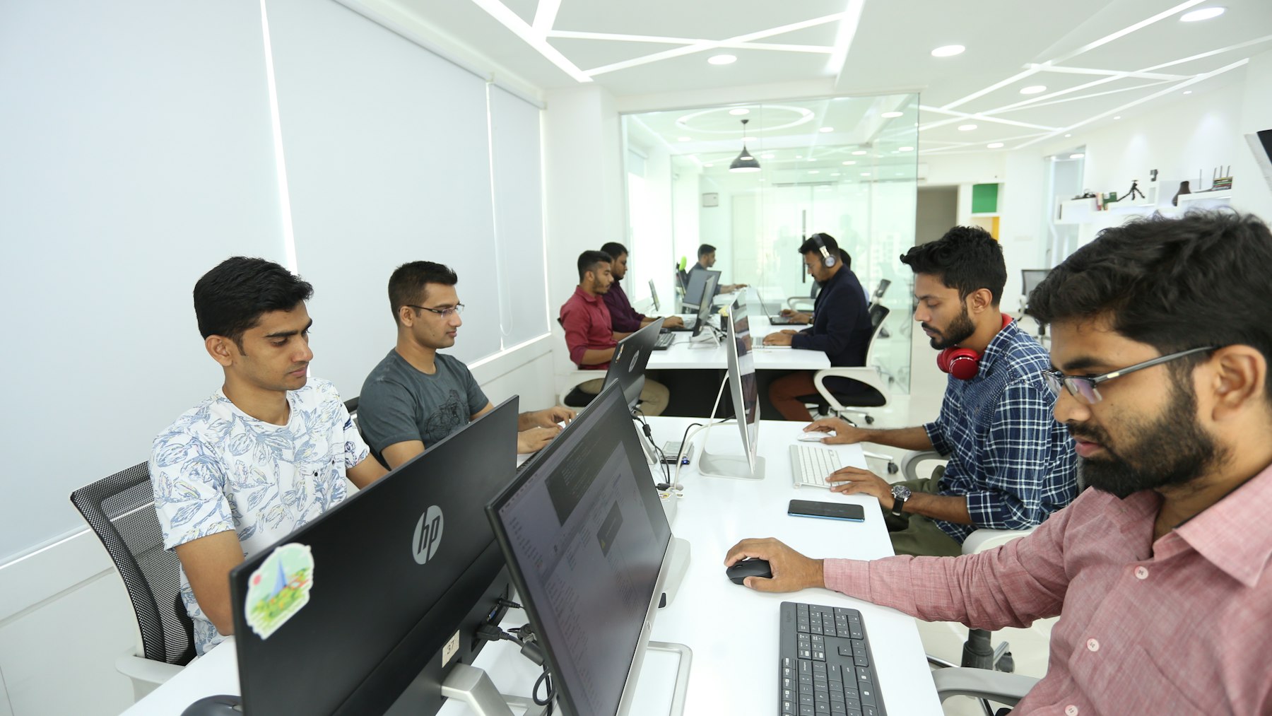 Engineers working at a row of workstations in a training session.